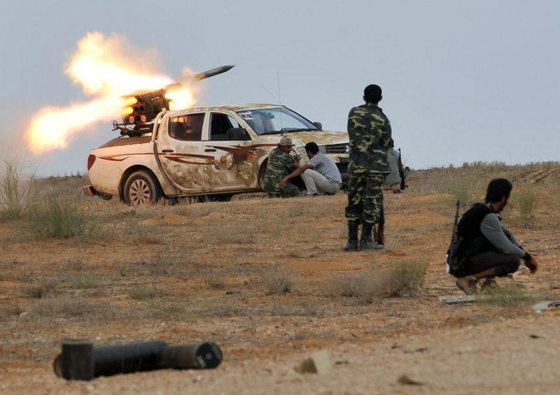 Libyan revolutionary fighters launch a missile during an attack Saturday on the city of Sirte, where forces loyal to Moammar Gadhafi are still entrenched.