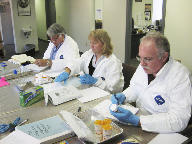 Volunteer pharmacists, from left, Bill Miller, Kerry Kenney and Milton Stein inventory drugs to be discarded in 2009. A collection event will be held Oct. 29 at sites in Maine.