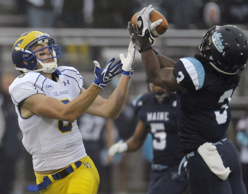 Trevor Coston of the University of Maine, right, intercepts a pass intended for Delaware’s Mark Schenauer in the first quarter of a Colonial Athletic Association football game Saturday at Orono. The Black Bears had four interceptions on the way to a 31-17 victory.