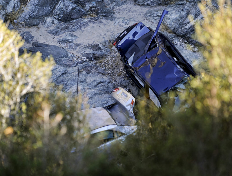 Two vehicles sit at the bottom of a ravine in Castaic, Calif., on Friday, a day after they were discovered. The car on the right belongs to David Lavau, 67, who survived six days in the ravine. Investigators are “99 percent sure” that the body that was in the other vehicle is that of Melvin Gelfand, 88, the car’s owner.
