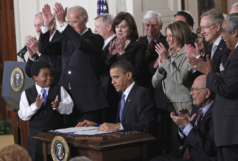 President Obama is applauded after signing the health care bill in the East Room of the White House in Washington on March 23, 2010. The Supreme Court begins its new term today, and Obama’s health care overhaul, which affects almost every American, is squarely in its sights.