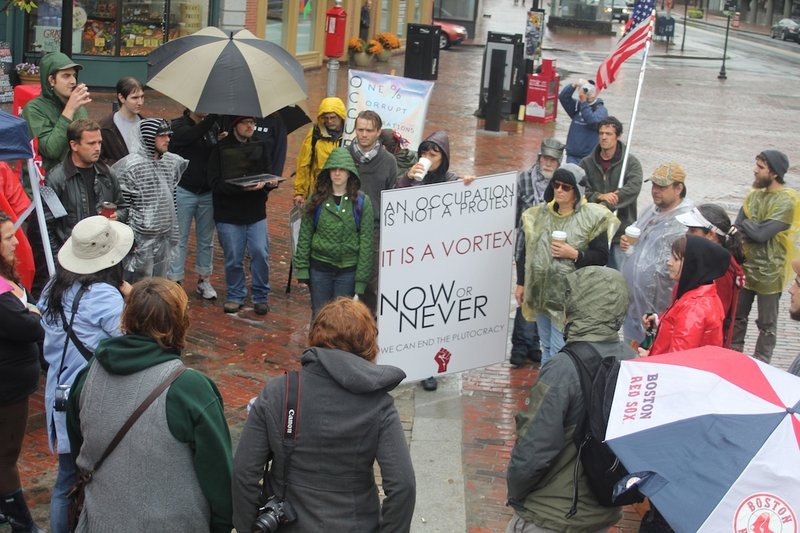 Demonstrators gather in Monument Square in Portland on Sunday as part of a nationwide protest against Wall Street.