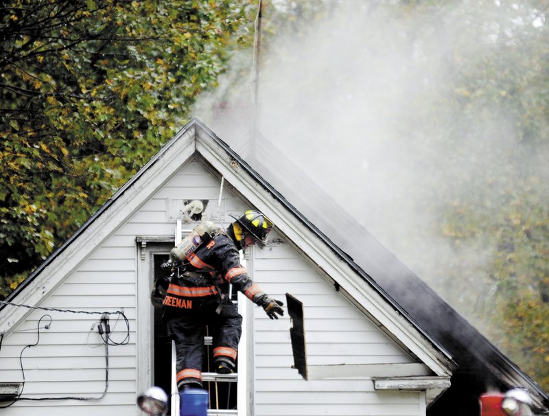 A firefighter removes a smoldering clapboard Sunday from a Richmond house that caught fire and injured a boy. The blaze heavily damaged the home and left a 9-year-old boy with burns over 60 percent of his body, officials said. According to Richmond’s fire chief, the state Fire Marshal’s Office has confirmed that the boy started the fire by playing with a lighter.