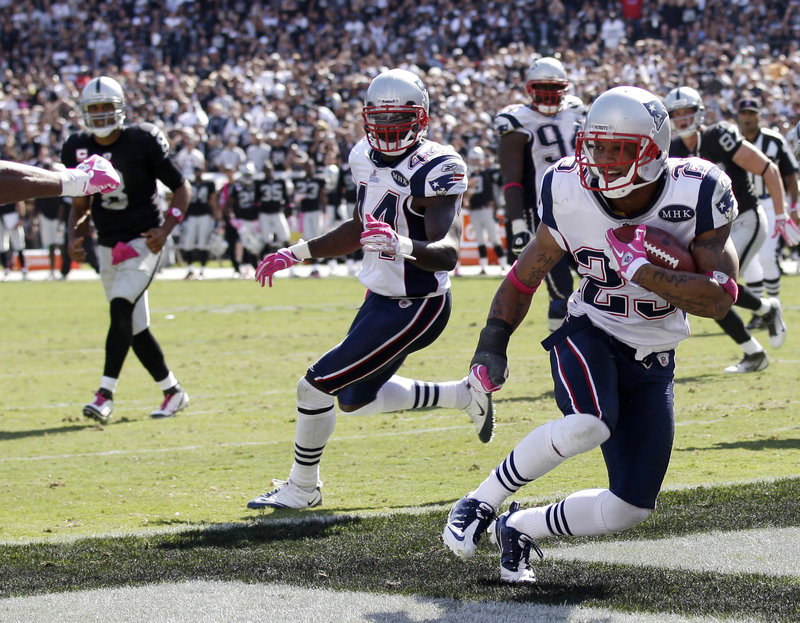 Patriots safety Patrick Chung picks off a pass in the end zone Sunday as teammate James Ihedigbo looks on. It was the first of two interceptions by New England.