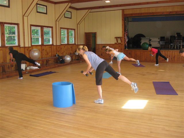Participants in Julie Waterman’s cardio strength workout class at Cumberland-North Yarmouth Adult Education work on maintaining their balance.