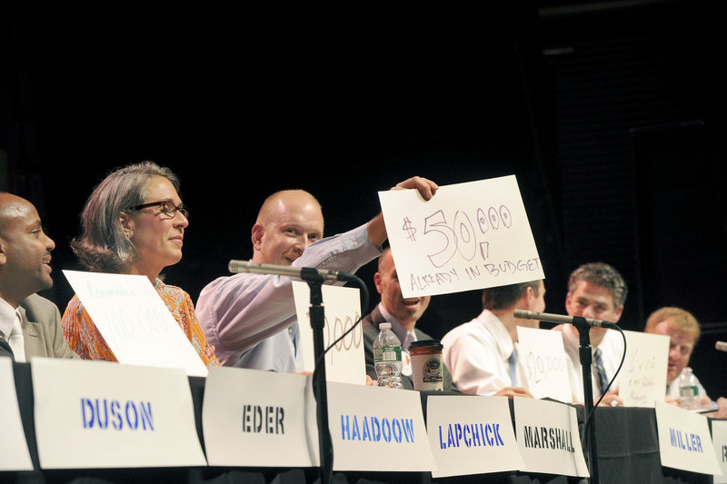 David Marshall holds up his answer to a question as the Portland Music Foundation and the Portland Arts & Cultural Center Alliance hosted the fourth mayoral forum at the State Theatre in Portland on Monday.