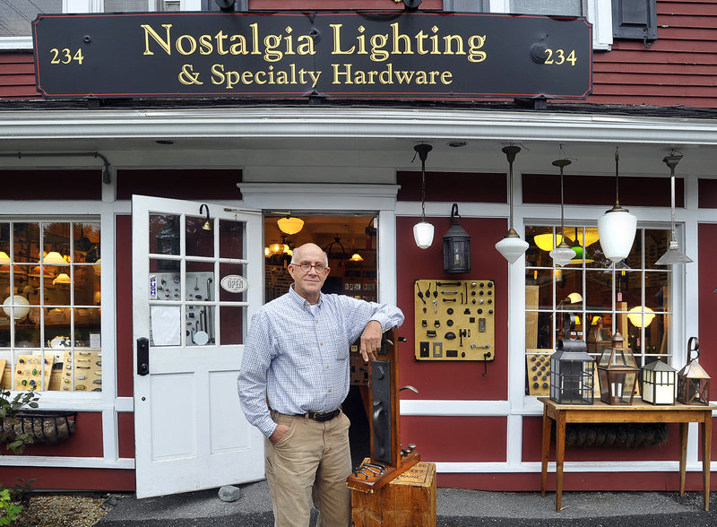 Nick Harding stands with a Rocky Mountain entrance set and other products outside his Falmouth store.