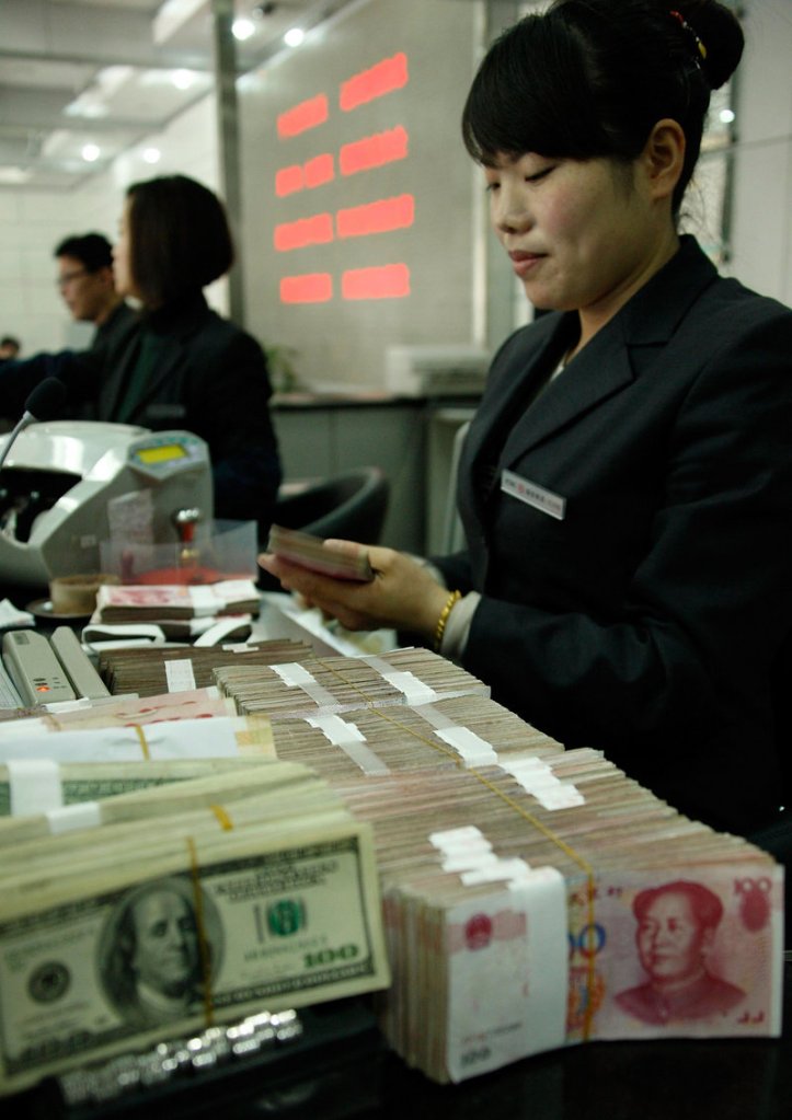 A clerk counts money at a Bank of China in Huaibei. Maine Republican Sen. Olympia Snowe is a co-author of a key part of the China currency manipulation legislation. A final vote on the bill could come Thursday.