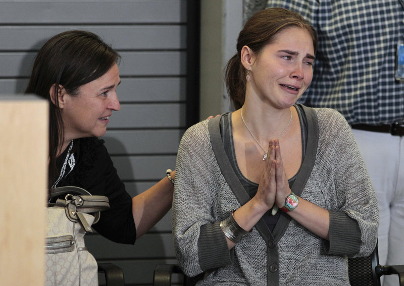 Edda Mellas comforts her daughter Amanda Knox at a news conference in Seattle on Tuesday. An Italian court overturned Knox’s murder conviction Monday.
