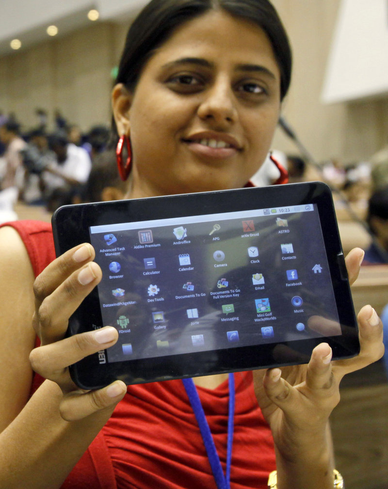 An Indian student shows off a supercheap Aakash tablet computer in New Delhi on Wednesday.