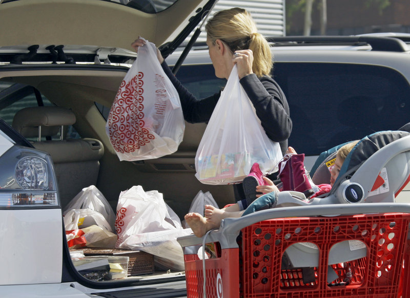 A woman loads purchases from a Target store into her car in Culver City, Calif. The National Retail Federation has low expectations for the holiday shopping season.