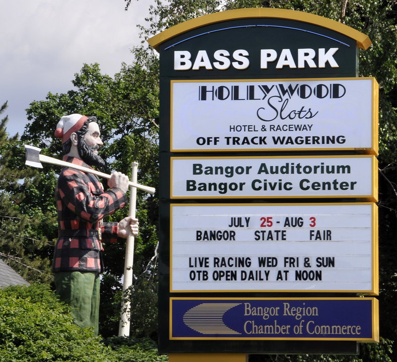 The Paul Bunyan statue stands next to a sign in Bangor for Bass Park, home of Hollywood Slots.