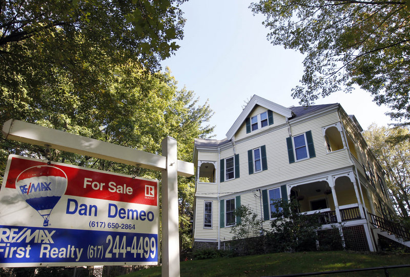 A sign advertises a home for sale last month in Newton, Mass. Even with mortgage rates among the lowest in history, buying a house is too big a risk for many Americans in the down economy.