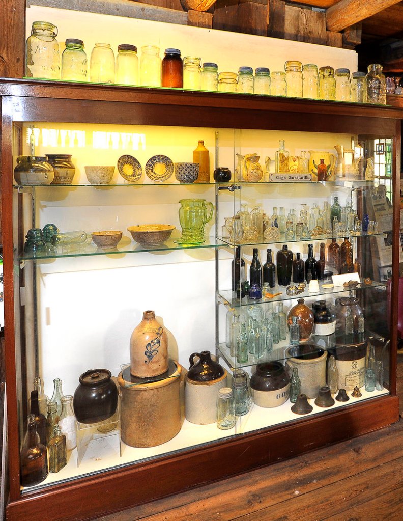 This case at the Maine Antique Bottle and Glass Museum in Bridgton contains many underwater and dig finds such as clay jugs, ink wells, salt shakers and bottles found in or near the Saco River, Androscoggin River and Stevens Brook.