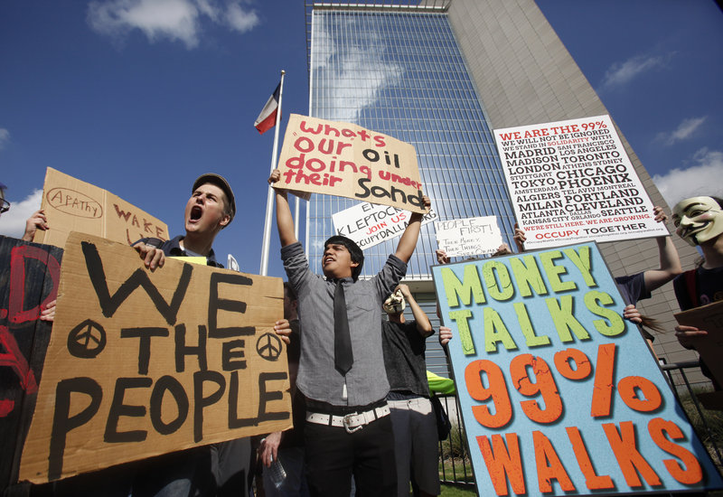 Demonstrators chant slogans Thursday outside the Federal Reserve Bank of Dallas. Rallies across the nation focused on the weak economy and corporate influence on government.