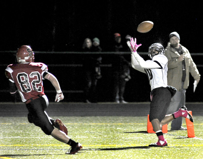 Renaldo Lowry of Deering hauls in a touchdown pass ahead of Conor McCann of Scarborough – the second score for the Rams in a 14-7 victory Thursday night.