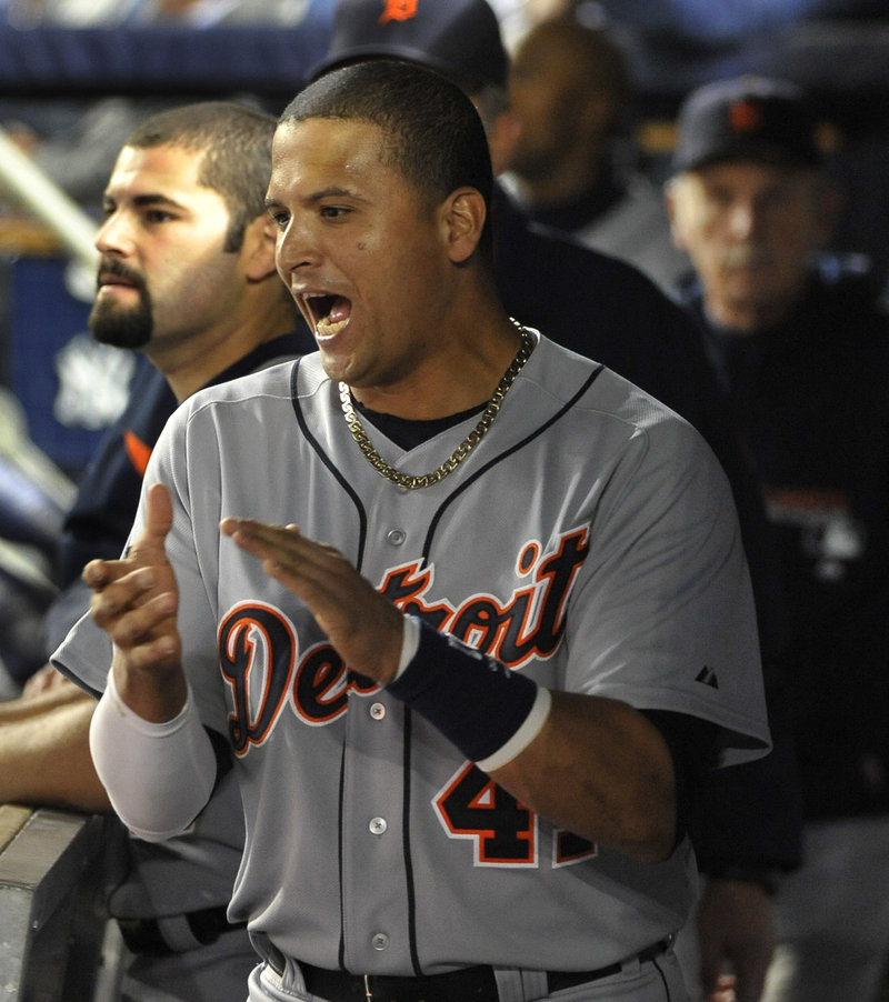Victor Martinez of the Detroit Tigers celebrates in the dugout Thursday night after teammate Don Kelly homered in the first inning of the 3-2 victory against the New York Yankees in Game 5.