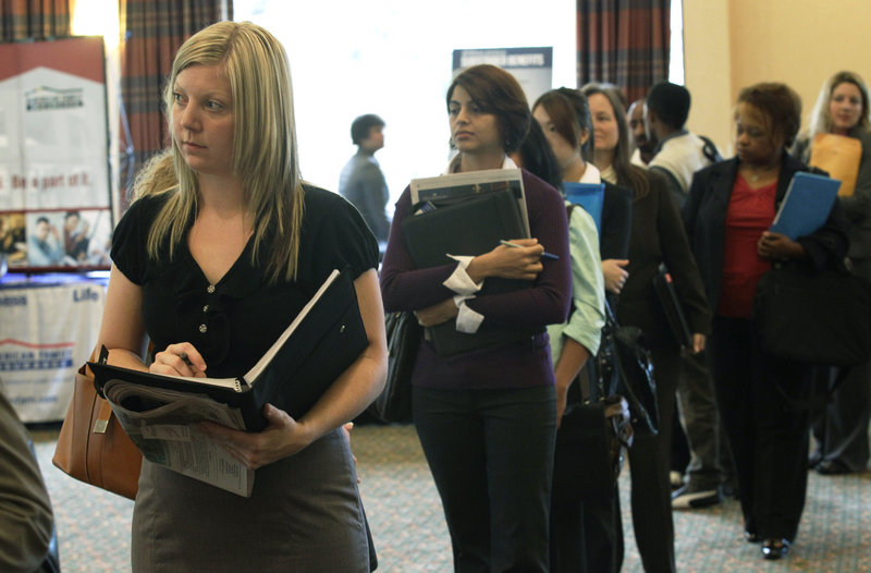 Annelie Ingvarsson, left, waits in line to talk to potential employers during a National Career Fairs job fair in Bellevue, Wash., last month. The United States added 103,000 jobs in September, an improvement over this summer and just enough to calm fears of a new recession that have hung over Wall Street and the nation for weeks.