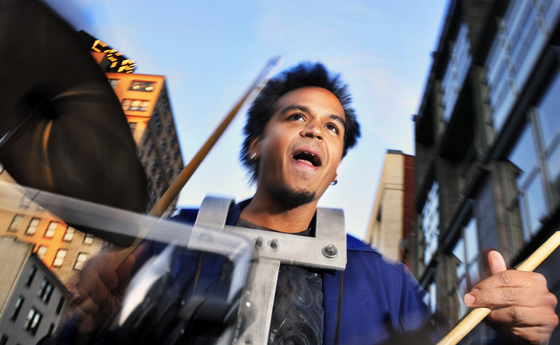 Sunny Jain, a drummer with the New York City-based Asphalt Orchestra, leads the group up Congress Street from Monument Square to Longfellow Square during October’s First Friday Art Walk.