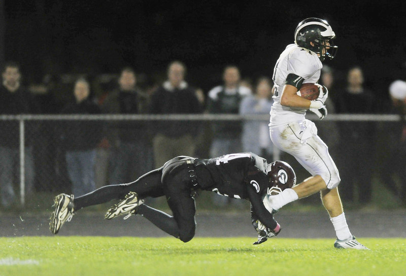 Joe Jackson of Gorham makes a touchdown-saving tackle Friday night, bringing down Cam Cooper of Bonny Eagle at the Gorham 1 after Cooper hauled in a long pass. But the Scots scored soon after and went on to win, 29-22.