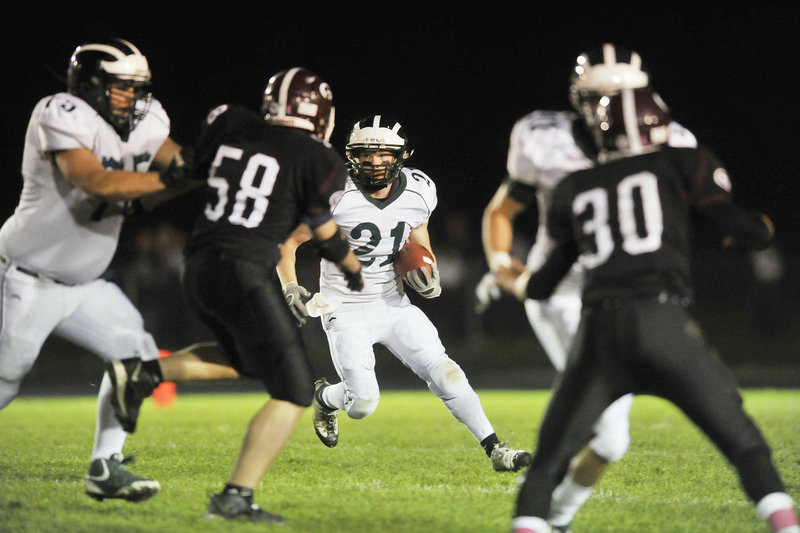 Nick Adkins, who gained 90 yards for Bonny Eagle, looks for a way around the Gorham defense Friday night during the 29-22 victory against the Rams.