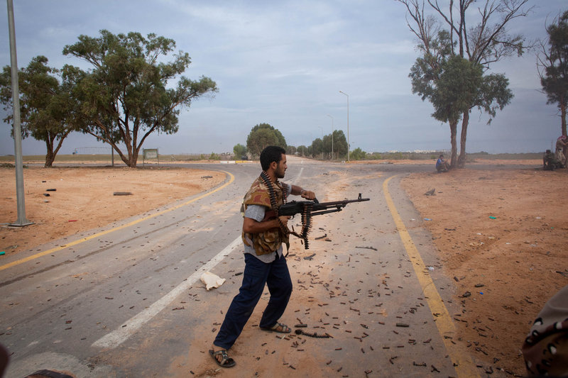 Libyan revolutionaries fire toward pro-Gadhafi forces in Sirte, Libya, on Saturday. Scattered resistance has stalled a rebel takeover of Sirte, under siege for weeks.
