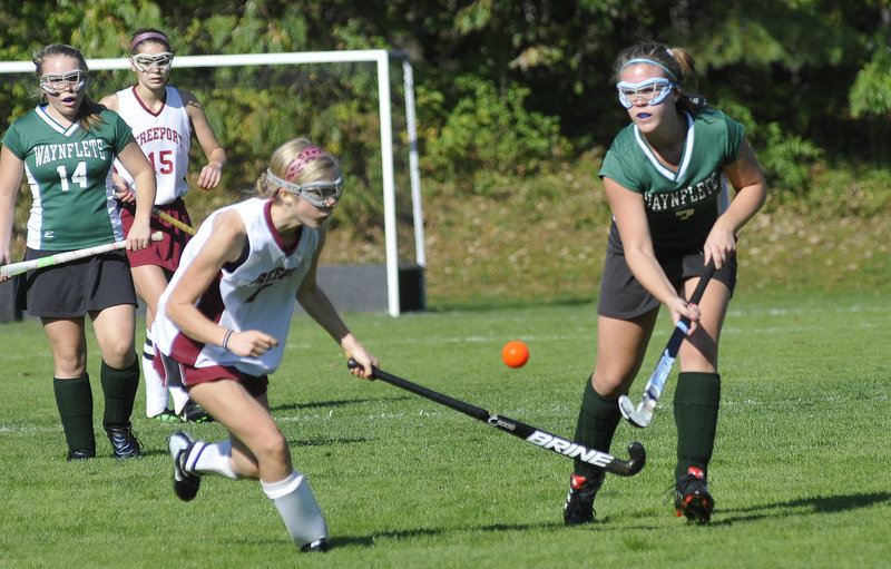 Abby Mahoney, left, of Freeport goes for the ball with Chloe Williams of Waynflete during their Western Maine Conference field hockey game Saturday. Waynflete won, 4-1.