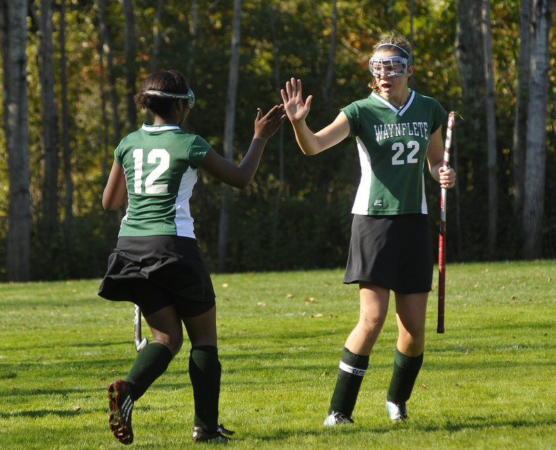 Merilla Michael, left, of Waynflete is congratulated by Jo Moore after scoring in the first half Saturday in a 4-1 victory against Freeport.