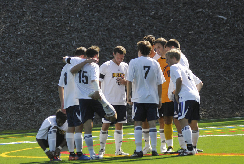 The University of Southern Maine men's soccer team huddles around its captain, Jeff Soules, before the start of the second half of Saturday's game against Plymouth State.