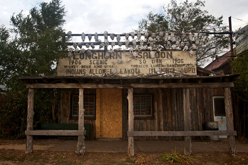 The Longhorn Saloon, adorned with cattle skulls and marked with the building's founding date of 1906, is among the properties included when the town of Scenic, S.D., was sold to a Filipino church whose intentions aren't known to locals.