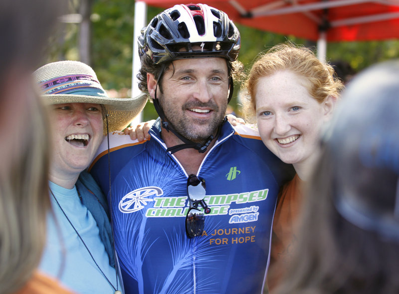 Actor Patrick Dempsey poses for a photo with Shawne McCord, left, and her daughter Lia Wellen, 17, both volunteers from Freeport, at a rest stop in Mechanic Falls during The Dempsey Challenge on Sunday.