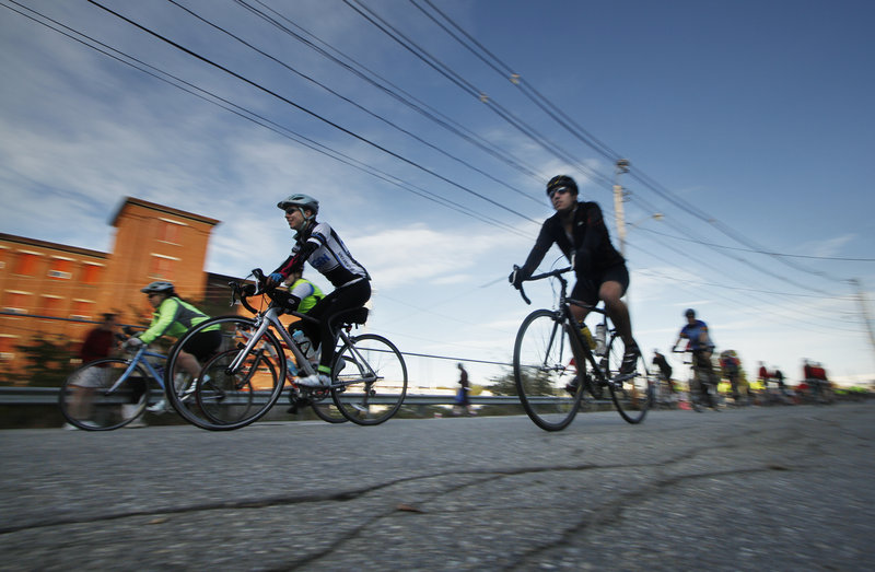 Bicyclists ride along Oxford Street in Lewiston at the start of the course for The Dempsey Challenge on Sunday.