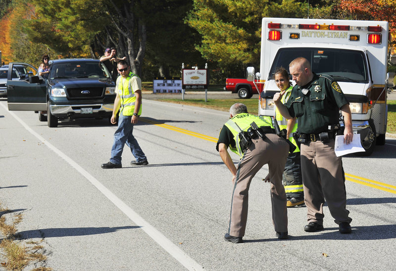 Sgt. Roger Hicks of the York County Sheriff’s Office examines skid marks at the scene of a crash at Gould and New County roads in Dayton on Monday. Seven people were hospitalized with injuries that didn’t appear life-threatening, Hicks said.