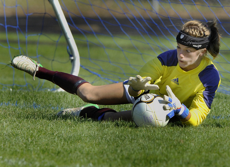 Gorham goalkeeper Sarah Perkins dives to make a save on a Kennebunk shot in the second half Monday during unbeaten Gorham's 6-0 victory in a Southern Maine Activities Association schoolgirl soccer game.