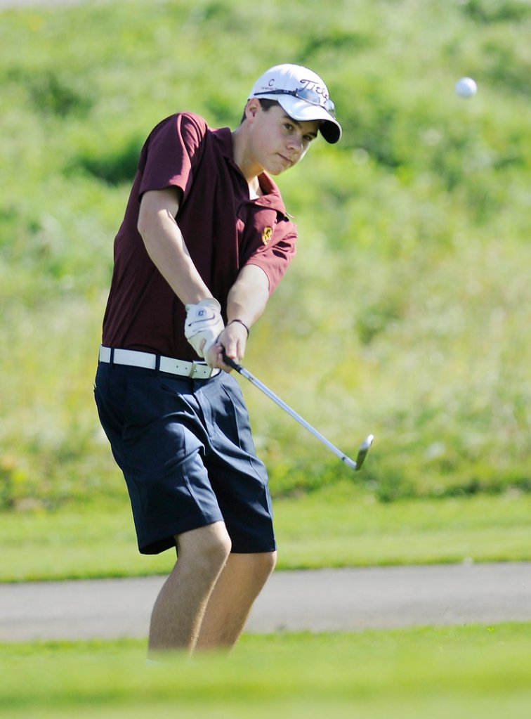 Jackson Berman of Cape Elizabeth keeps his eyes on the ball while sending it onto the green during the Class B state meet, which was won by York.