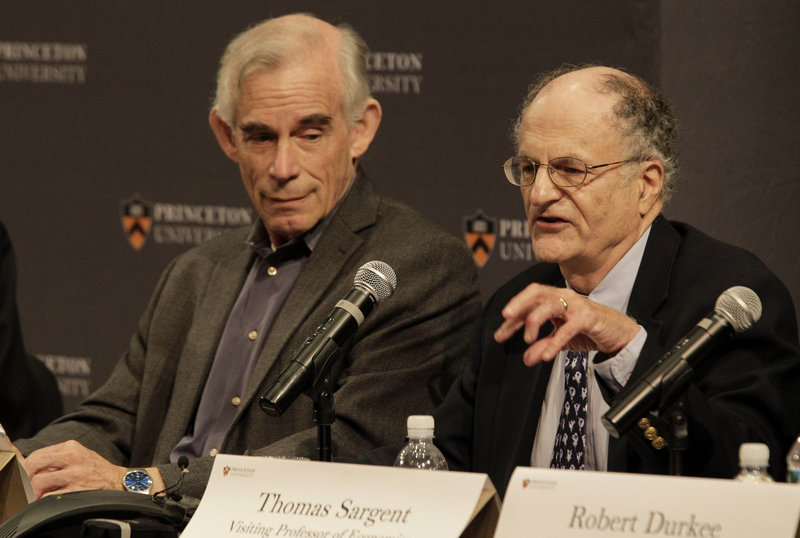 Christopher Sims, left, listens as Thomas Sargent talks about winning the Nobel Prize on Monday in Princeton, N.J.
