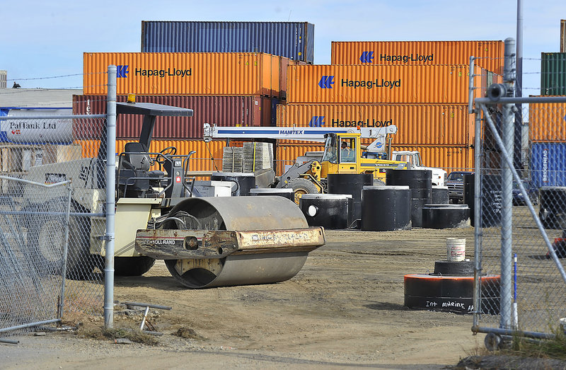 The pavement in a parking lot at the marine terminal has been removed as workers prepare to reinforce the surface so the lot can be used as additional storage for cargo containers.