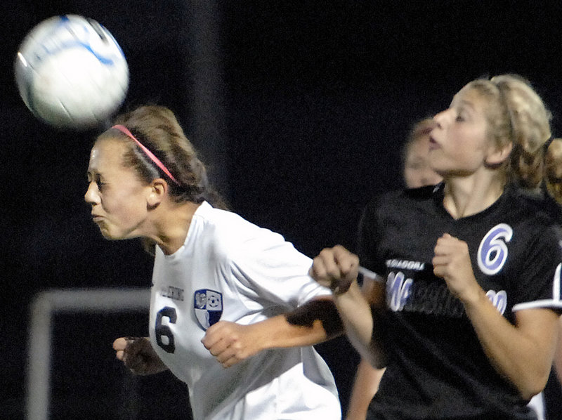 Alexis Sivovios of Deering heads the ball away from Korinne Bohunsky of Marshwood during the second half of Deering's 3-0 victory Tuesday.