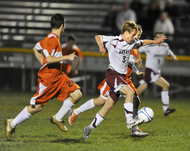 Mitchel Donovan of Greely controls the ball and drives through the North Yarmouth Academy defense Monday during the first half of Greely’s 5-1 victory.