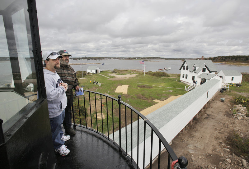 Martin Cain, right, and his son, Marty, take in the view from the Goat Island Lighthouse on Wednesday. Martin was the lighthouse keeper in 1978 when a storm flooded the island and washed away the covered walkway between the keepers’ quarters and the lighthouse. The walkway was replaced as part of a restoration of the lighthouse and other buildings on the island.