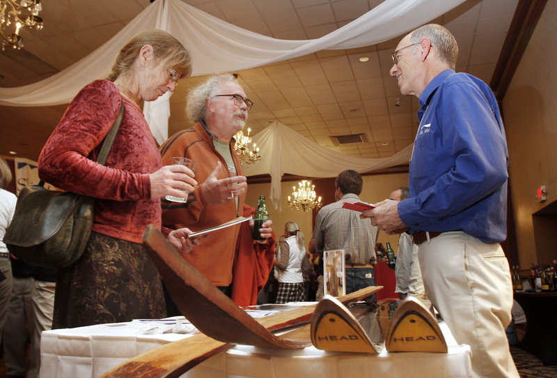 Greg Sweetser, right, executive director of Ski Maine Association, talks with Jay York, a ski instructor at Mt Abram, and Kris Horton, a ski enthusiast from Portland, at the Ski Season Launch Party at Eastland Park Hotel.