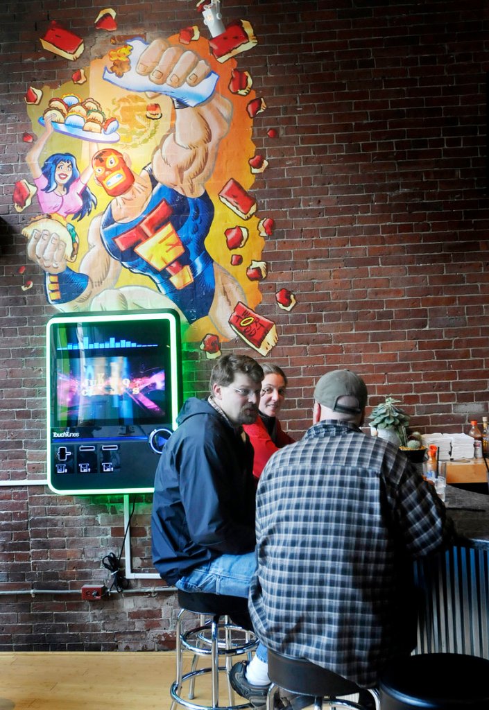 Patrons enjoy the atmosphere and food at Taco Escobarr in Portland.