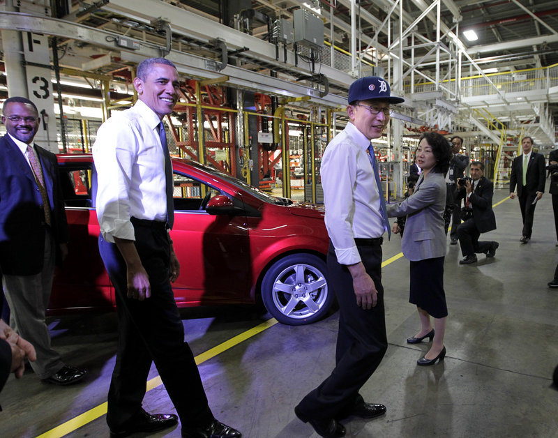 President Barack Obama and South Korean President Lee Myung-bak, wearing a Detroit Tigers baseball cap, tour the General Motors Orion Assembly Plant in Orion Township, Mich., on Friday to promote the free-trade agreement between Washington and Seoul that was passed by Congress last week. The GM operation is a U.S. and South Korean collaboration where the subcompact Chevrolet Sonic is produced. The agreement with South Korea also could help open doors to more trade with China and Japan.