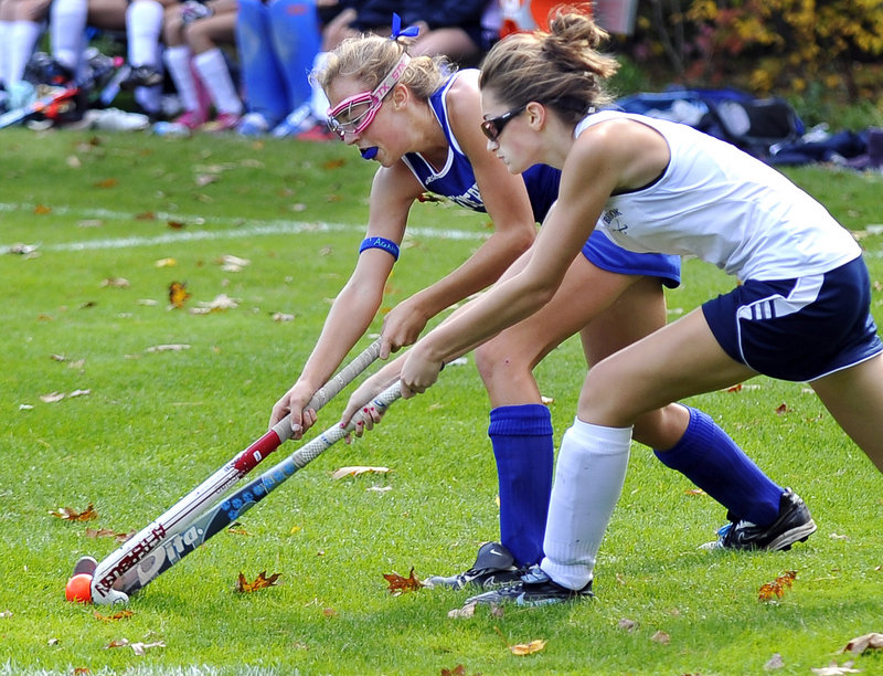 Megan Cadigan, left, of Kennebunk battles with Westbrook’s Katie Berry during their Western Class A field hockey prelim Saturday. Westbrook won in overtime, 1-0.