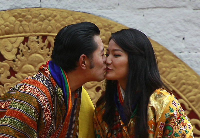 Bhutan’s King Jigme Khesar Namgyal Wangchuck and Queen Jetsun Pema kiss in front of the crowd at a stadium as part of their wedding celebration in Bhutan on Saturday.
