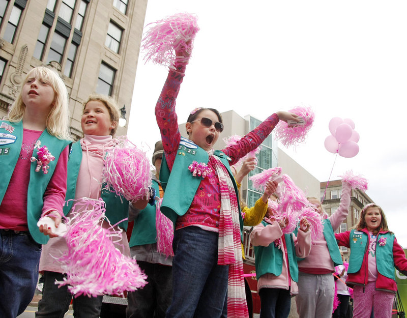 Sydney Seely, center, of Junior Girl Scout Troop 2135 in Limerick is joined by fellow Scouts, at left, Samantha Dudley and Lindsey Hutchins as they cheer Making Strides participants Sunday.