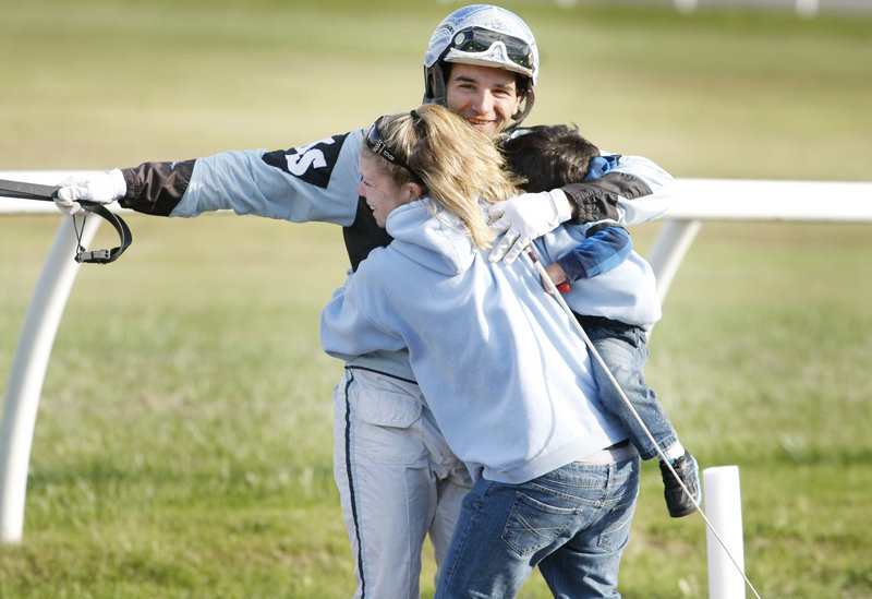 Kevin Switzer Jr. is greeted by his wife, Liz Switzer, and son Garrett, 2, as he makes his way to the winner’s circle after riding CBF Fancy to the victory.