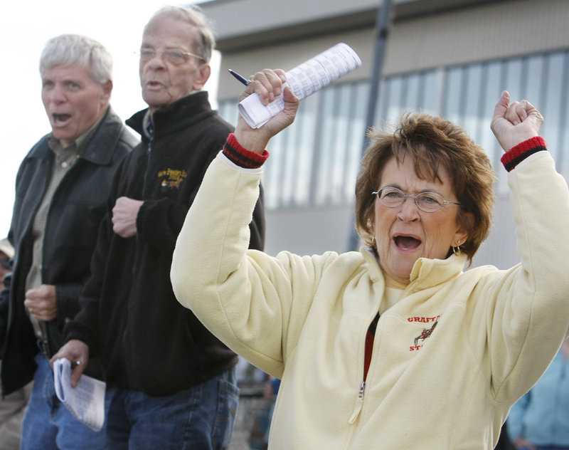 Judy Ambrose of Falmouth cheers for her son, driver Michael Graffam, as he drives Riot Act in a 1-mile trot.