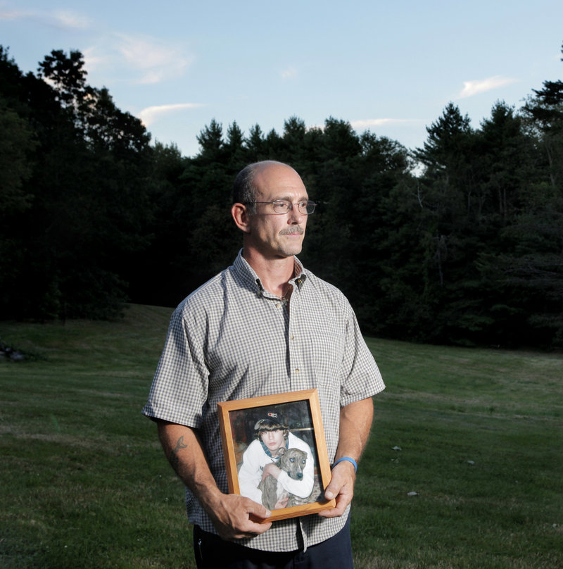 Matt Rix holds a photo of his son, Matty, in his backyard in South Berwick. Matty, who planned to join the Marines, died of a fentanyl overdose in 2009.