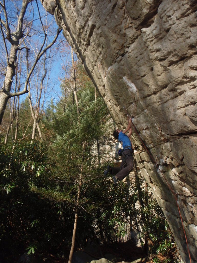 Maine Rock Gym manager, instructor and coach Chuck Curry climbs a rock face.